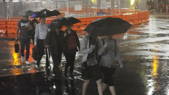 Inner city commuters get drenched as the rains roll in. Picture: Gordon McComiskie