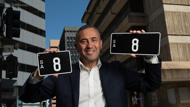 Transport Minister Tom Koutsantonis with the highly sought-after “number 8” licence plates. Picture: Naomi Jellicoe