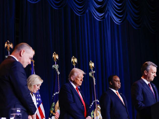 US President Donald Trump (C) bows his head during the National Prayer Breakfast at the Washington Hilton in Washington, DC, on February 6, 2025. (Photo by Ting Shen / AFP)