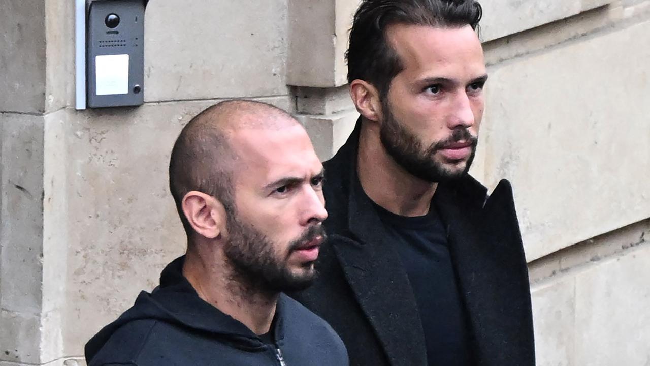 Andrew Tate (L) and his brother Tristan Tate exiting a court in Bucharest, Romania. (Photo by Daniel MIHAILESCU / AFP)