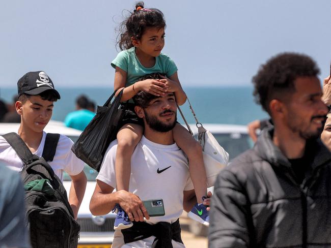 Displaced Palestinians take the coastal Rashid road to return to Gaza City as they pass through Nuseirat in the central Gaza Strip. Picture: AFP