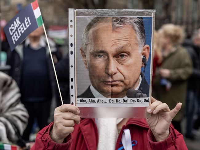 Protesters hold and anti-Orban placard during a demonstration on March 15 in Budapest. Picture: Getty