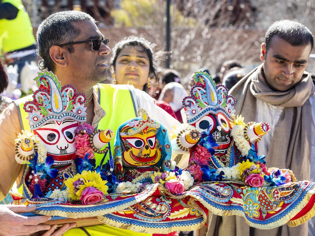 The Hare Krishna deities of Baladev, Subhadra and Jagannath are carried from the chariot by Medhavi Das as the Festival of Chariots procession reaches the Civic Square, Saturday, July 20, 2024. Picture: Kevin Farmer