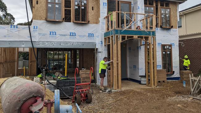 Workers on Metricon construction site on in Mt Waverley. Picture: Kiel Egging