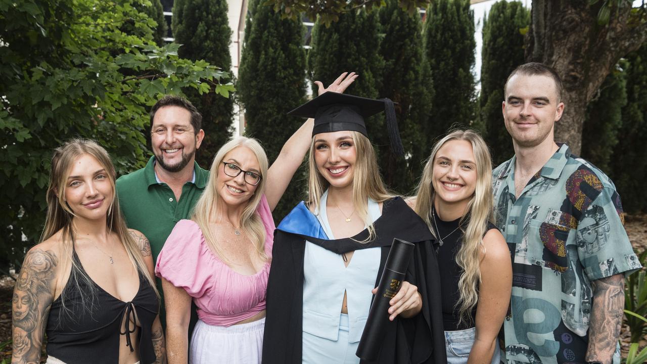 Bachelor of Nursing graduate Madison Whitehouse celebrates with (from left) Brittany Whitehouse, Brad Rissman, Cassii Young, Tayla Whitehouse and Byron Guthrie at a UniSQ graduation ceremony at Empire Theatres, Tuesday, February 13, 2024. Picture: Kevin Farmer