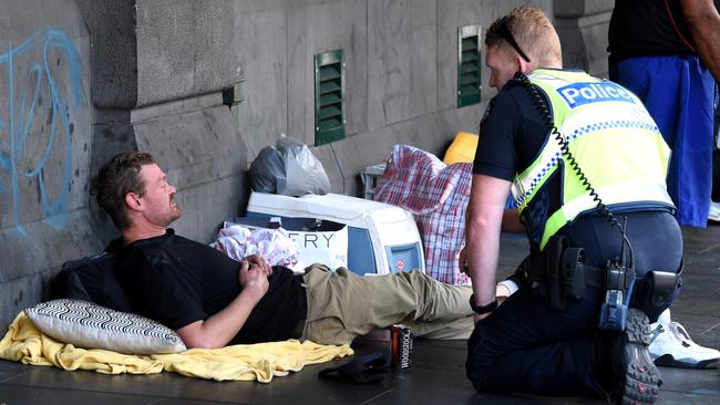 Police speak to the man before taking him into custody at 11.20am. Picture: Nicole Garmston