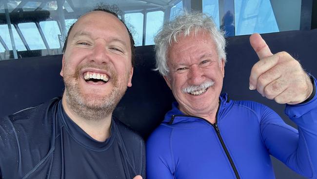 Nicholas Meyer with his father, Adrian Meyer aboard the Reef Experience tour boat near Cairns on Monday, November 20, 2023.