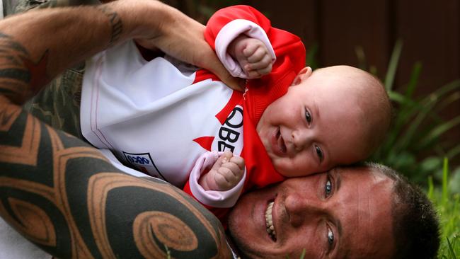 Peter Everitt with his four-month-old son Boston after joining the Swans.