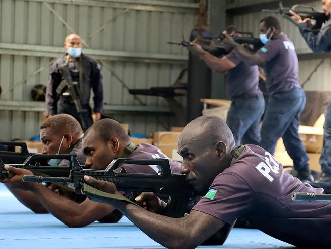 An undated handout photo released on March 29, 2022 by the Royal Solomon Islands Police Force (RSIPF) shows China Police Liason Team officers training local RSIPF officers in drill, unarmed combat skills, advanced usage of long sticks, round shields, tactical batons, T-shape baton, handcuffs, basic rifle tactics and crowd control. (Photo by Handout / RSIPF / AFP) / ----EDITORS NOTE ---- RESTRICTED TO EDITORIAL USE MANDATORY CREDIT " AFP PHOTO / ROYAL SOLOMON ISLANDS POLICE FORCE" NO MARKETING NO ADVERTISING CAMPAIGNS - DISTRIBUTED AS A SERVICE TO CLIENTS