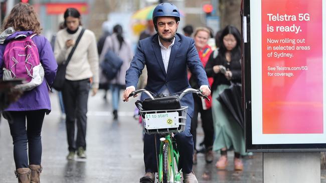 Sam Dastyari arrives at the ICAC hearing in Sydney on a hired pushbike. Picture John Grainger