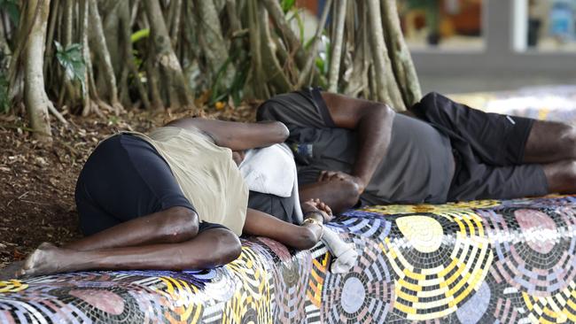 A homeless woman and man sleep on a garden bed in the Shields Street Mall. Picture: Brendan Radke