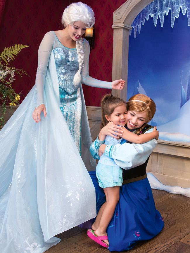 A four-year-old fan meets her Frozen princess idols at Disneyland. (Picture: Getty)