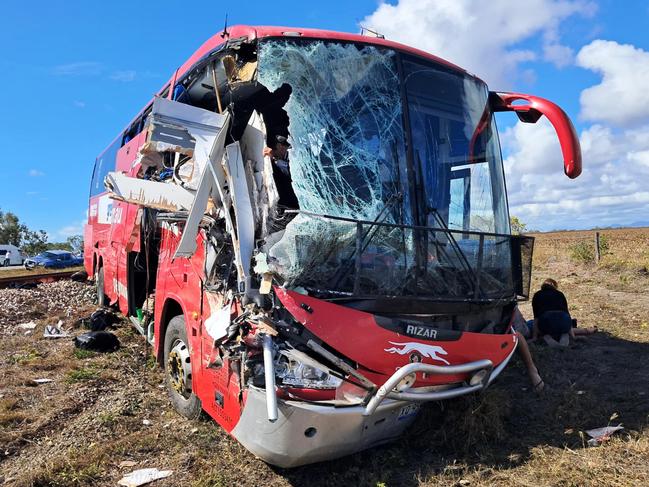 Supplied image from a passenger of a Greyhound bus and caravan crash near Gumlu. The bus driver looking out at the damage after the crash.