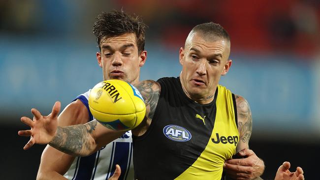 Richmond vs North Melbourne at Metricon Stadium, Gold Coast. 18/07/2020. Dustin Martin of the Tigers tries to get [ossession infant of Jy Simpkin of the Kangaroos Q4 . Pic: Michael Klein