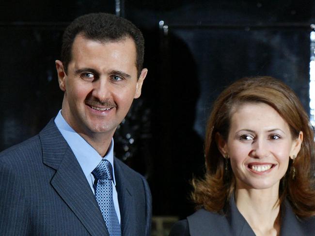 (FILES) Syrian President Bashar al-Assad (L) poses with his wife Asma (C) and Britain's Prime Minister Tony Blair (R) outside No.10 Downing Street in London 16 December 2002. Islamist-led rebels declared that they have taken Damascus in a lightning offensive on December 8, 2024 sending President Bashar al-Assad fleeing and ending five decades of Baath rule in Syria. (Photo by Adrian DENNIS / AFP)