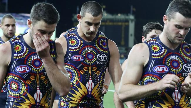 MAN IN THE MIDDLE: Under-fire Crows captain Taylor Walker (centre) trudges from Adelaide Oval after the loss to West Coast, flanked by Rory Atkins (left) and Brad Crouch. Picture: SARAH REED.