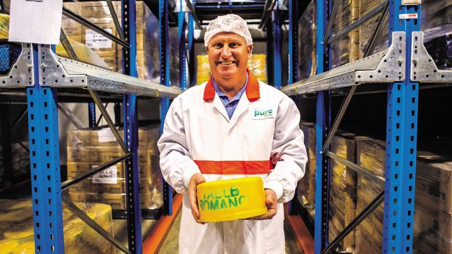 Beston Global Food Company's master cheesemaker Paul Connolly with a wheel of romano cheese. Picture: Beston/Supplied