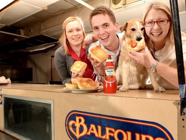 Ashlee Crossman, Ben Jarvis, Melissa Cox and Buddy the dog explore one of Adelaide’s retired pie carts, now at Old Tailem Town near Tailem Bend. Picture: Dave Cronin