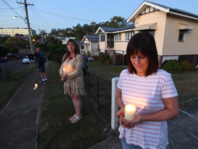 People stand outside their homes at dawn to commemorate Anzac Day in Brisbane, Saturday, April 25, 2019. Anzac Day is a national day of remembrance to commemorate the service and sacrifice of Australian and New Zealand service men and women. Due to COVID-19 restrictions marches and commemorative services have been banned for the first time in more than a century. (AAP Image/Dan Peled) NO ARCHIVING