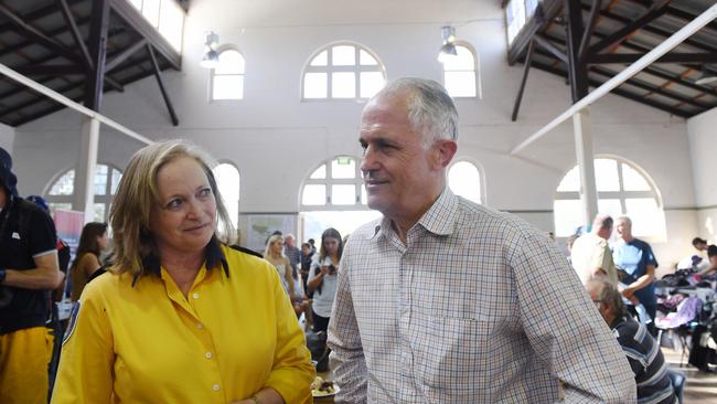 Prime Minister Malcolm Turnbull talks to Sharon Kelly from the Bundendore RFS during a visit to the evacuation centre in Bega. Picture: AAP