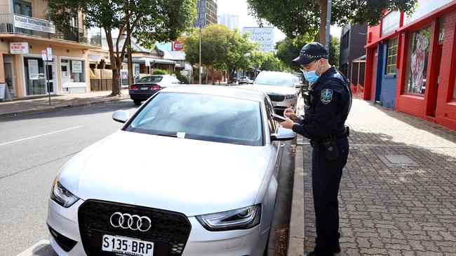 A police officer with one of the cars in Wright Street. Picture: Kelly Barnes