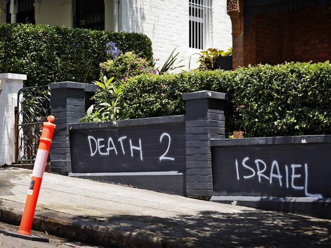 DAILY TELEGRAPH - 11.12.24A car is set alight and anti semitic graffiti  sprayed on homes in Magney St Woollhara. A cleaner paints over the graffiti. Picture: Sam Ruttyn