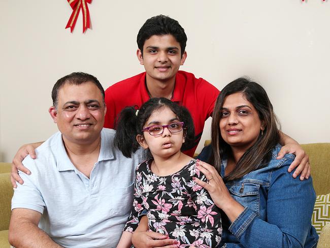 Riaa Kulkarni, 7, with her family at their home in Melbourne. Riaa was given two weeks to live in August 2017. Parents Vivek and Sheetal took her to a Mexican cancer treatment centre and her tumour has shrunk by 40 per cent. Picture: Ian Currie