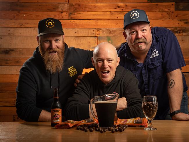 Robern Menz CEO Phil Sims (centre) with Big Shed Brewery owners Craig Basford and Jason Harris and Bruchocs stout. Picture: Brad Fleet