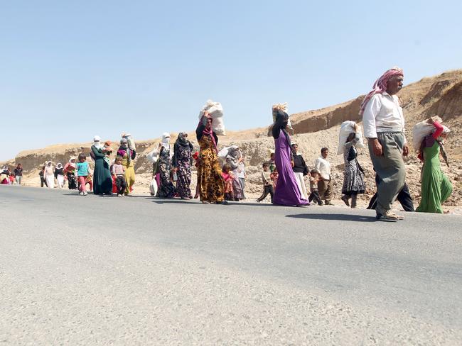 Displaced Iraqi families from the Yazidi community cross the Iraqi-Syrian border at the Fishkhabur crossing to safety, in northern Iraq. Picture: Ahmad Al-Rubaye