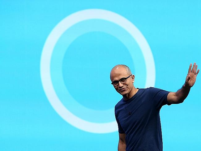 Every circle has a centre ... Microsoft CEO Satya Nadella walks in front of the new Cortana logo.