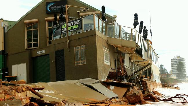 The Beach Club at Collaroy was battered by the storm, with it’s balcony hanging by a thread and a hole through the middle ... but boss hopes to reopen tomorrow