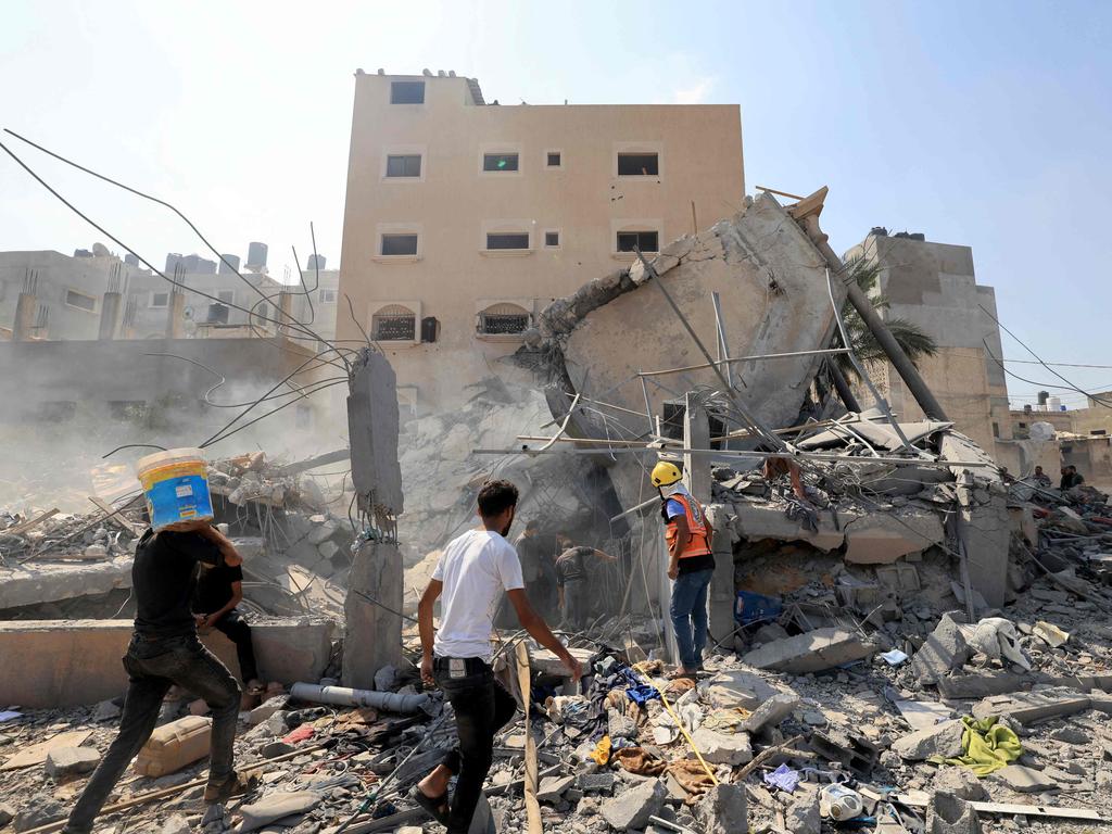 Palestinians survey the rubble of a collapsed building following an Israeli strike in Khan Yunis in the southern Gaza Strip amid the ongoing battles between Israel and the Palestinian Islamist group Hamas. Picture: AFP