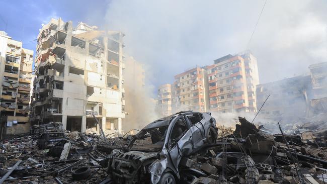 Smoke seeps out from building rubble at the site of an Israeli airstrike on the Laylaki neighbourhood in Beirut's southern suburbs. Picture: AFP