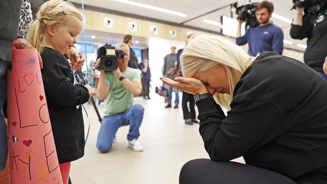 Sadie Myors, 4 is reunited with her aunty Emily Myors as the first flight into the state as borders reopen lands. Picture: Zak Simmonds