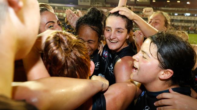 Lucy McEvoy celebrates the win over the Tigers with teammates, including Madi Prespakis. Picture: AFL Photos/Getty Images