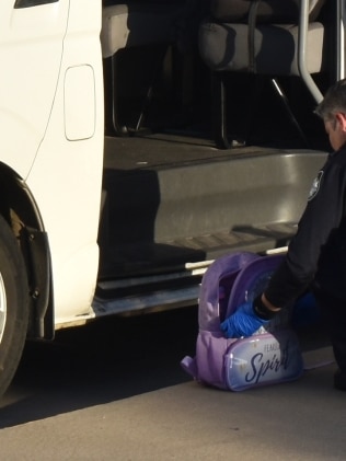 Police inspecting a bag at Le Smileys Early Learning Centre where the three-year-old was left inside a bus. Picture: Vanessa Jarrett