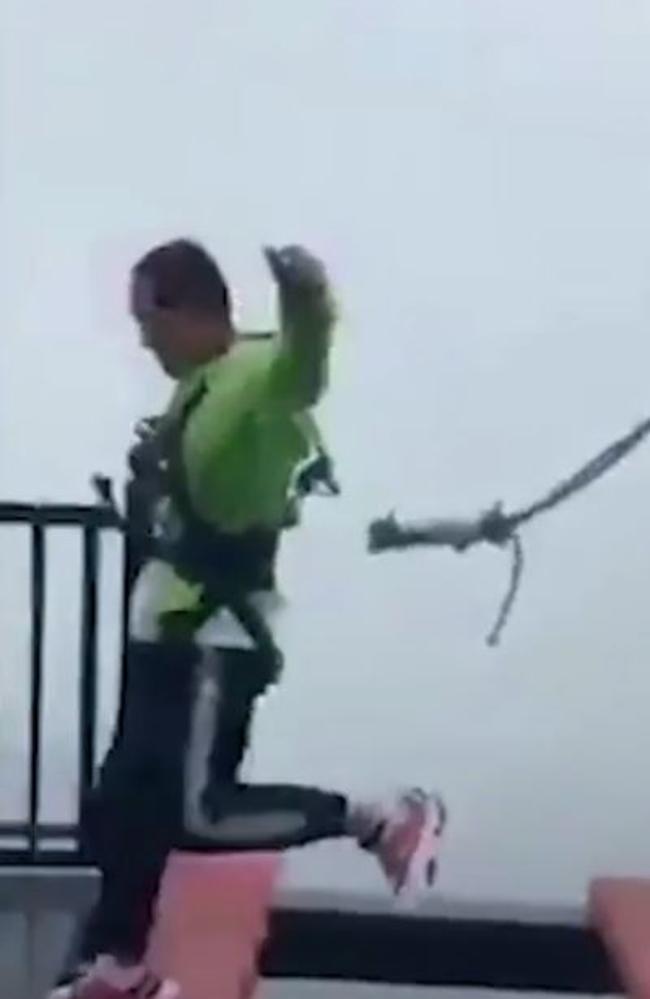 This is the moment a tourist's safety harness snaps off during a bridge stunt at a Chinese theme park. Picture: Weibo