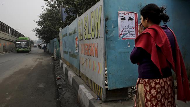 An Indian woman waits at a bus stop where the victim of a deadly gang rape in a moving bus had boarded the bus two years ago, in New Delhi, India, Tuesday, Dec. 16, 2014. The case sparked public outrage and helped make women’s safety a common topic of conversation in a country where rape is often viewed as a woman’s personal shame to bear. (AP Photo/Altaf Qadri)