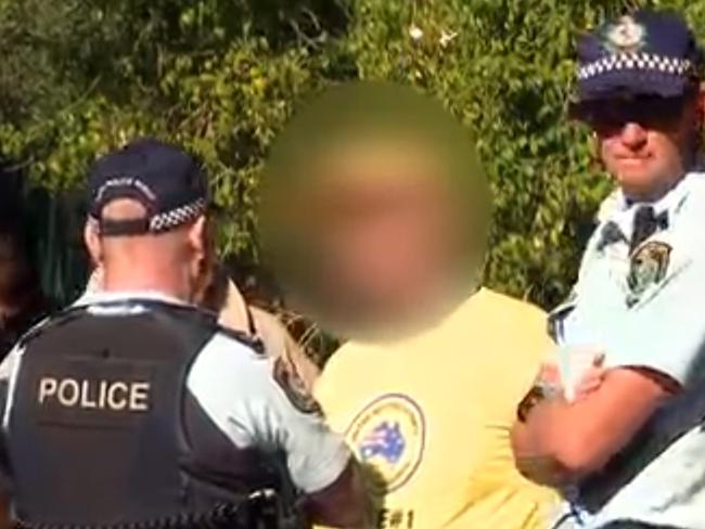 A supporter of Clive Palmer's Australia United Party is pictured after he was issued a fine for offensive conduct at a polling booth in Bankstown. Picture: SBS