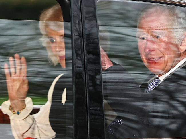 TOPSHOT - Britain's King Charles III and Britain's Queen Camilla wave as they leave by car from Clarence House in London on February 6, 2024. King Charles III's estranged son Prince Harry reportedly arrived in London on Tuesday after his father's diagnosis of cancer, which doctors "caught early". (Photo by HENRY NICHOLLS / AFP)