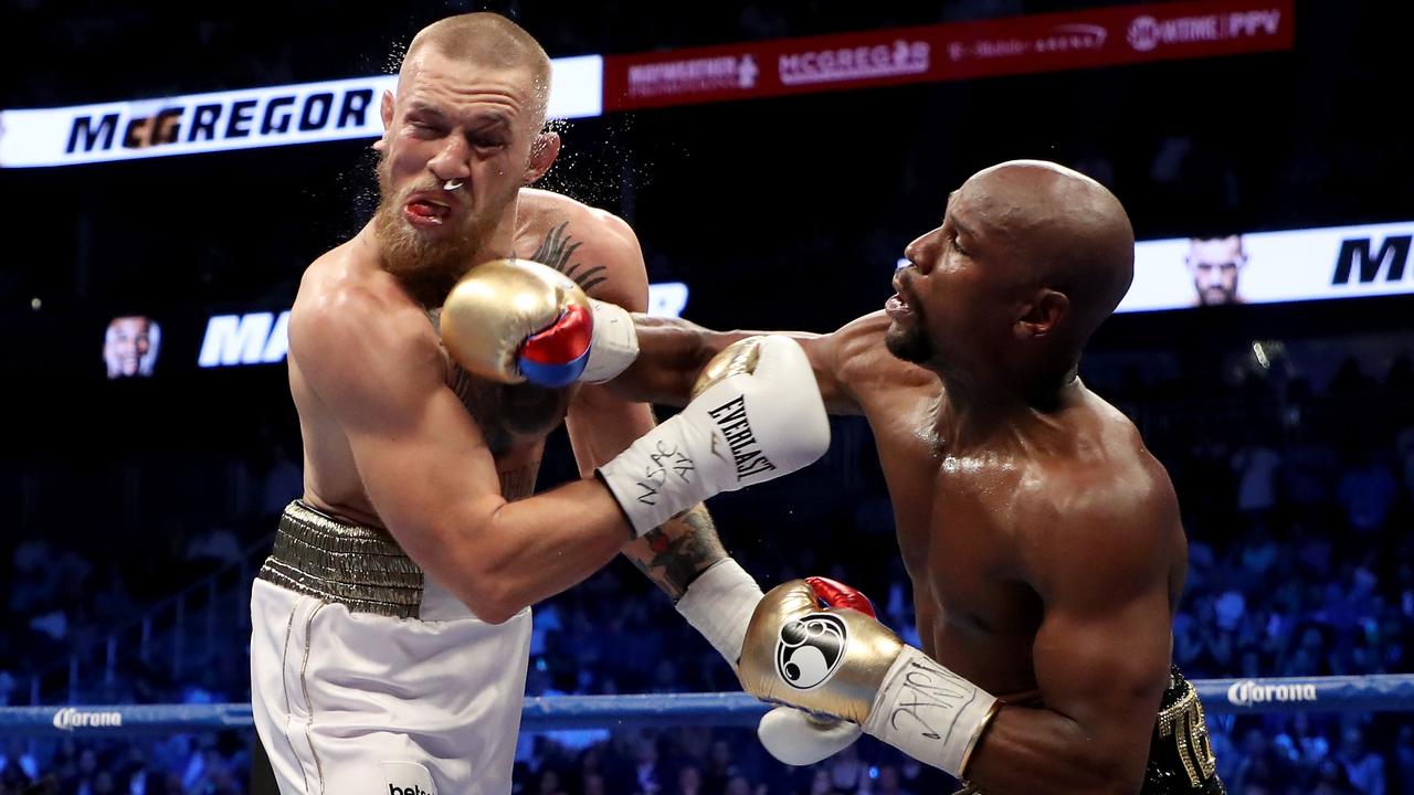 Conor McGregor is punched during his loss to Floyd Mayweather in 2017. (Photo by Christian Petersen/Getty Images)