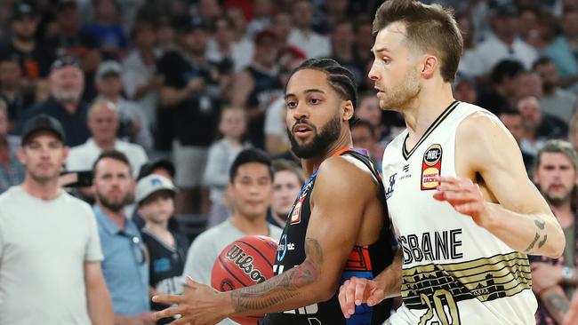 Melo Trimble puts some body on Brisbane’s Nathan Sobey. Picture: Michael Klein