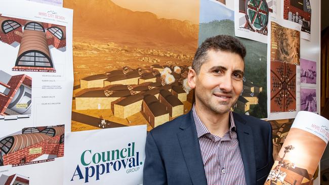 Giuseppe Calabrese stands in front of his winning plans for the Mars City Design Urban Farming Challenge 2020. Picture: Craig Peihopa