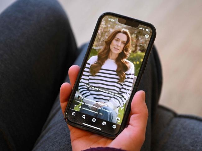 A woman in the village of Marsden, northern England, watches a recording of Britain's Catherine, Princess of Wales, announcing her cancer diagnosis, on March 22. Picture: Oli Scarff/AFP