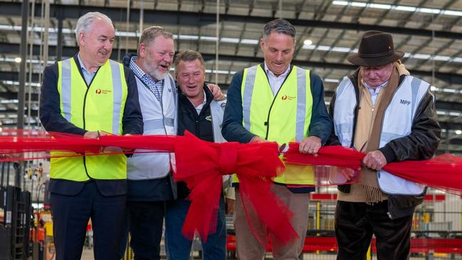 Australia Post recently opened its $75 million parcel facility at Avalon Airport. Cutting the ribbon are Australia Post chief executive Paul Graham, David Fox, Andrew Fox, Richard Marles and Lindsay Fox.