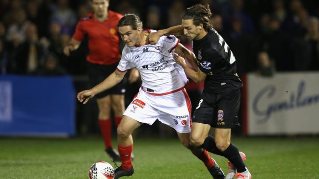 Matthew Ridenton tries to come to grips with Newcastle’s Tyson Jackson.