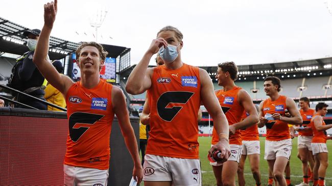 Lachie Whitfield and Harry Himmelberg walk off the field after beating Melbourne last week. Picture: Dylan Burns/AFL Photos via Getty Images