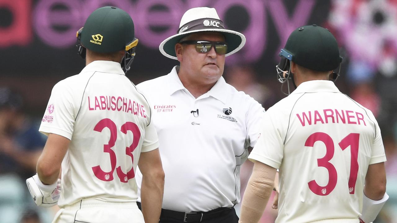 Umpire Marais Erasmus talks to Marnus Labuschagne and David Warner after Australia were penalised five runs for running on the wicket. Picture: AP