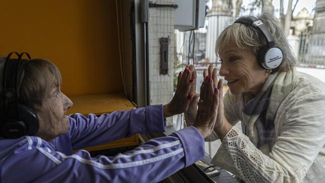 Felicia Waininger, 90, and her daughter Lilian visit through a window at Hogar Israelita nursing home in Montevideo, Uruguay. Picture: Getty Images.