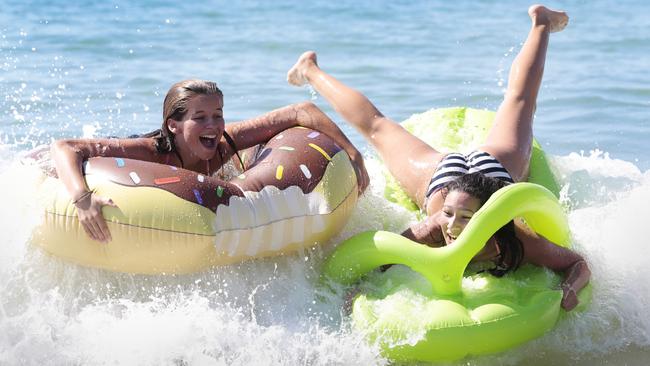 Friends Molly Cooper and Millie Murray make the most of their school holiday beach time at Noosa.